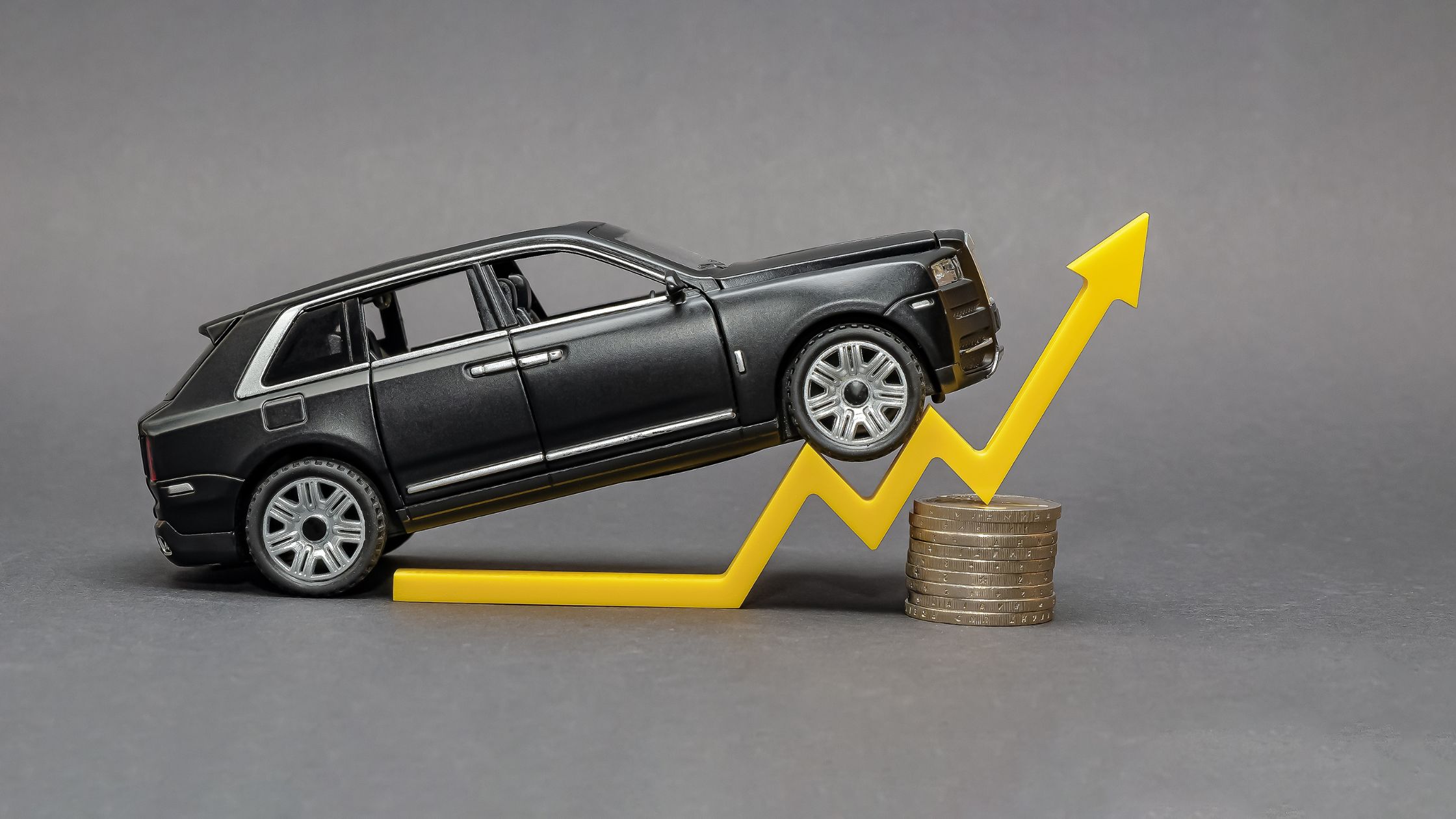 car driving up a soaring costs chart